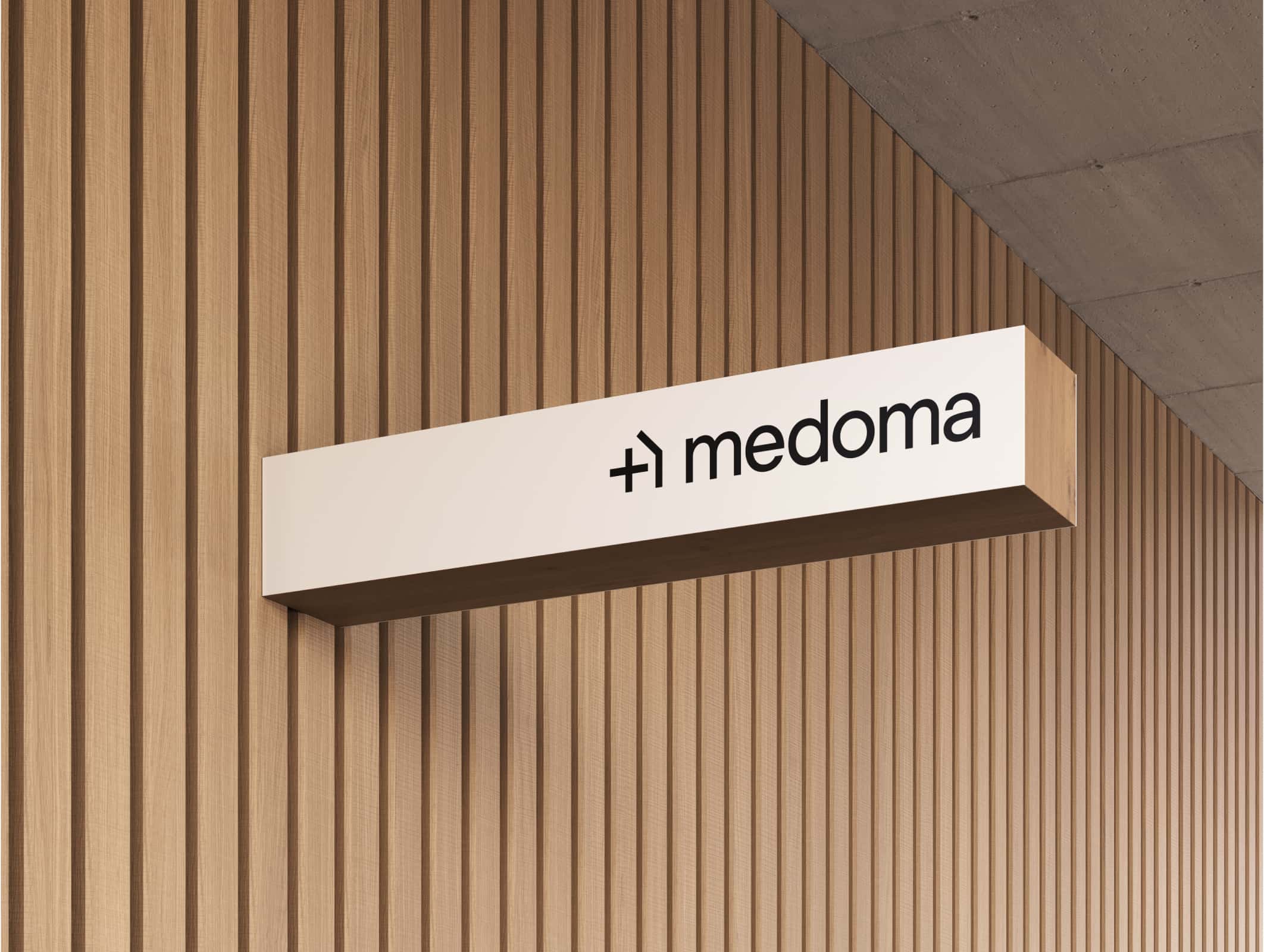 Medoma logo on a wooden wall